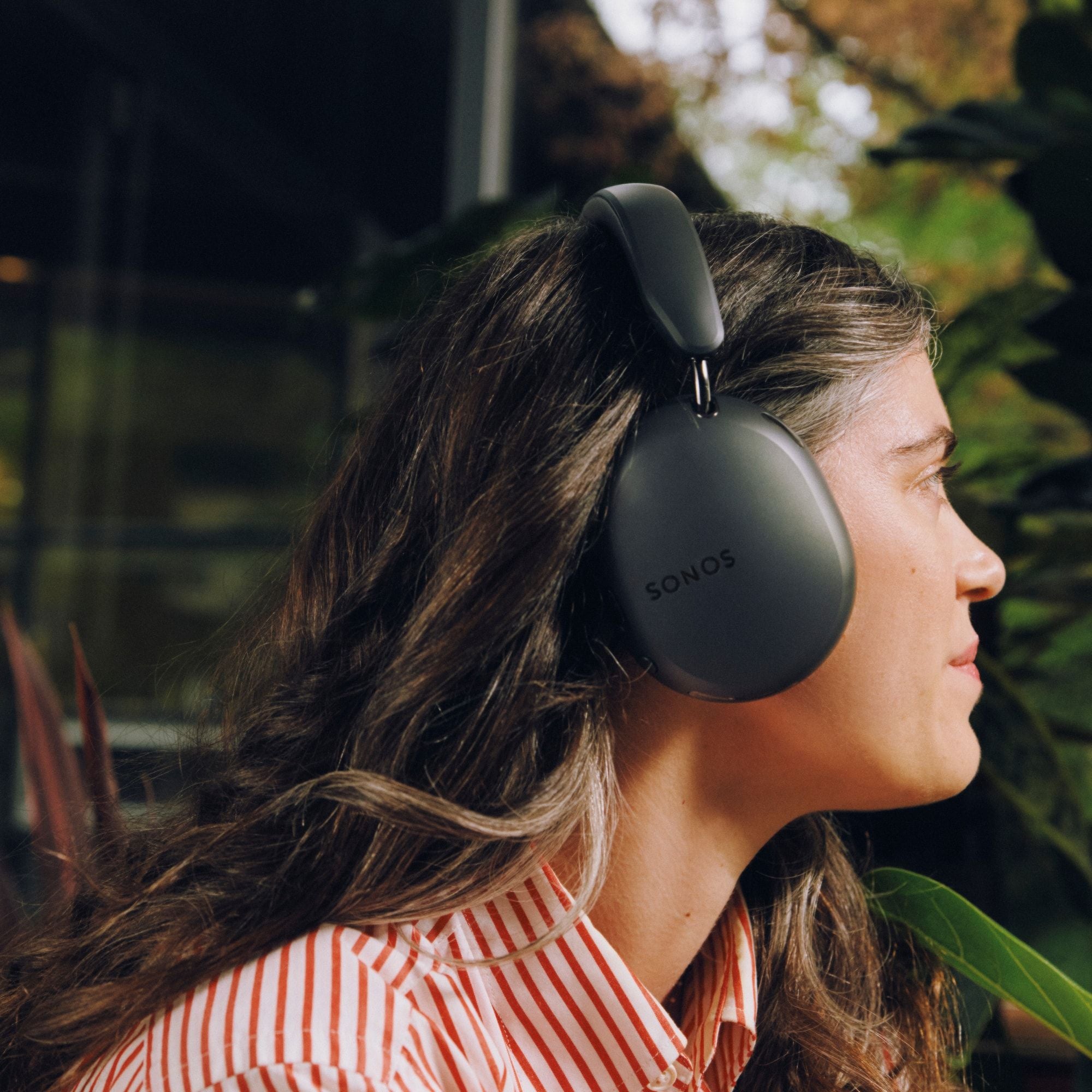 Wearing Sonos Ace Ultra headphones