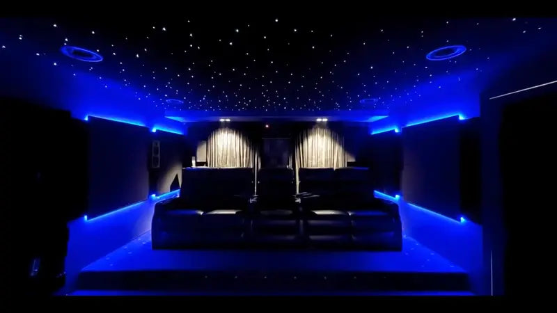 A listening room lit in blue under a starfield ceiling